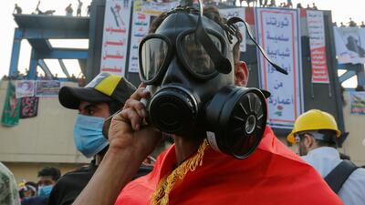 A demonstrator wears a mask to protect himself from tear gas. Reuters