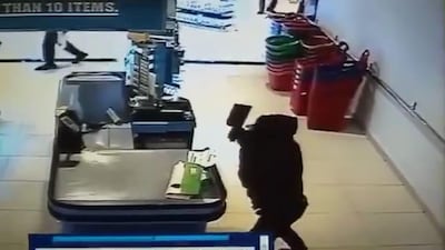 A screengrab of the surveillance footage from inside LuLu hypermarket shows one of the robbers carrying a meat cleaver.