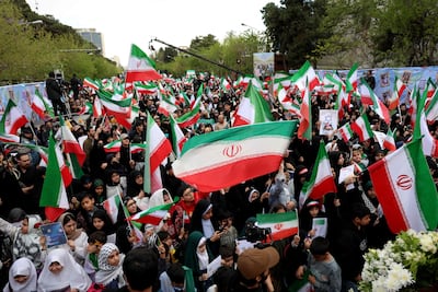 Iranians rally during a memorial for schoolchildren killed during the war. AFP