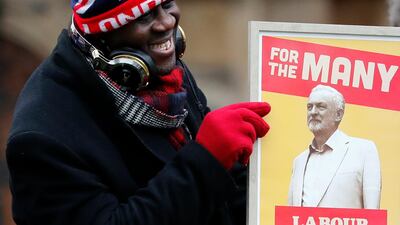 A protester holds a poster depicting Labour party leader Jeremy Corbyn in London. AP