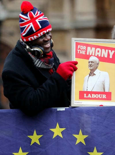 A protester holds a poster depicting Labour party leader Jeremy Corbyn in London. AP