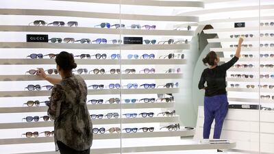 Shoppers look at sunglasses in Gucci. *** Local Caption *** sr-130827-galleria554.jpg