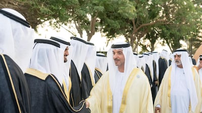 ABU DHABI, UNITED ARAB EMIRATES - November 27, 2018: HH Sheikh Hazza bin Zayed Al Nahyan, Vice Chairman of the Abu Dhabi Executive Council (R), greets a groom during a mass wedding reception for HH Sheikh Mohamed bin Khalifa bin Khaled Al Nahyan (not shown), at The Emirates Palace. ( Rashed Al Mansoori / Ministry of Presidential Affairs ) ---