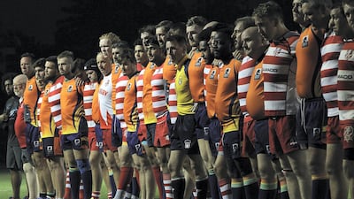 RAK Rugby and Arabian Knights observe a minute's silence for Nick Young, a RAK Rugby player who died after an on-field accident on April 27, 2018. Satish Kumar for The National