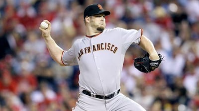 Brad Penny, making a winning debut for the San Francisco Giants, pitches against the Phillies.