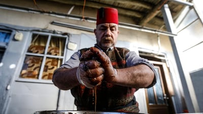 Ishaaq Kremed, a tamarind-juice seller, extracts juice from the fruit at his home in the Syrian capital Damascus. The popular street vendor says he usually has more customers during Ramadan, during which many Muslims favour the drink to break their day-long fast at sundown. AFP