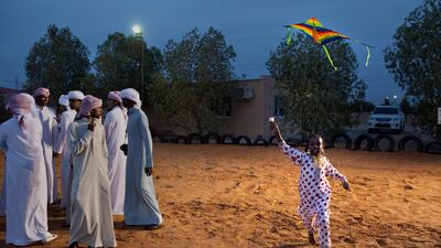 Al Ain, United Arab Emirates, January 30, 2013: Eight-year-old Hamda Jummeery runs with her kite as she and other children partake in a Family Day organized for the employees and the foster families of Dar Zayed for Family Care, a state-funded programme in Al Ain for abandoned, orphaned or neglected children, on Wednesday evening, Jan. 30, 2013, at the Al Bedaa Resort near Al Ain where the organization is based. The children attending Family Day were a mixture of staff children, children who live in Dar Zayed villas and children placed long-term with outside foster families. It is the second time Dar Zayed has held the Family Day event. Silvia Razgova / The National