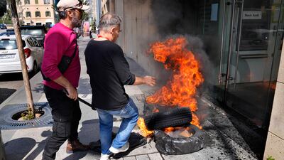 Protesters burn tyres outside the Bank Audi branch. Amid Lebanon's economic meltdown, bank customers have had restrictions on withdrawals since 2019. AP