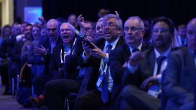 Business figures celebrate as they watch England v Iran on a big screen at the CBI annual conference at the Vox Conference Centre in Birmingham. PA