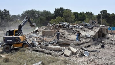 Afghan Security personnel work at the site of a suicide truck bombing in northern Balkh province of Afghanistan. AP
