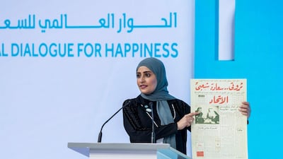 Ohood Al Roumi, Minister of State for Happiness and Wellbeing, holds up a newspaper dated November 11, 1971 with UAE Founding Father Sheikh Zayed's words as the headline: “My wealth is the happiness of my people”. Courtesy World Government Summit