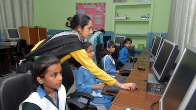 Children learn computer skills at City District Government Middle School, Chah Meeran, Lahore. In 2008, the school had 26 pupils and was on the verge of closing due to dilapidated conditions, lack of teaching staff and poor facilities. It was adopted by Seema Aziz’s Care Foundation and now teaches more than 1,100 pupils. Muzammil Pasha for The National
