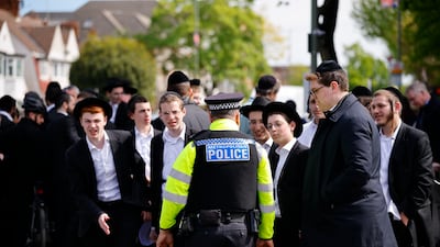 Police officers and members of the Jewish community. EPA