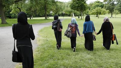 Yasmin (2nd L), 16, Hana (C), 16, and their friends walk in the park after finishing a GCSE exam near their school in Hackney, east London. Hana started wearing her headscarf full time aged 12. She was already wearing it at school and her family supported her so it was easy for her to make the decision. She says if felt like nothing had changed except her relationship with God.