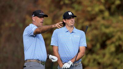 Stewart Cink and Reagan Cink look over a shot on the 18th hole. AFP