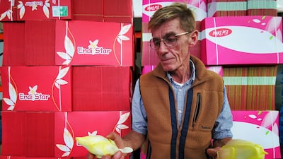 Farmer Emmanuel Lefebvre holds endives as he stands in front of empty boxes used in packaging in the De La Marliere production site in Bouvines, France. Reuters