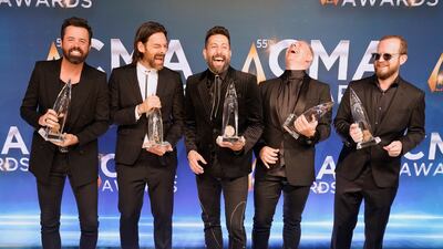 Old Dominion pose in the press room with the Vocal Group of the Year award. AP