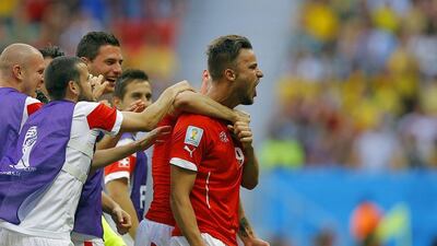 Haris Seferovic, right, celebrates his winning goal on Sunday against Ecuador at the 2014 World Cup in Brasilia, Brazil. Robert Ghement / EPA / June 15, 2014