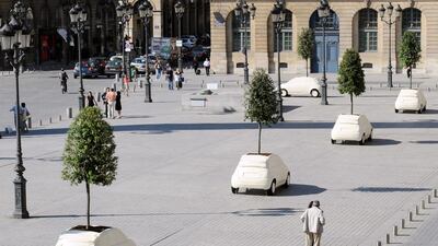Fibreglass sculptures by the famed architect and designer Fabio Novembre, inspired by the Fiat 500C model and containing a planted tree, at the prestigious Place Vendôme in Paris in a 2010 exhibition. AFP Photo