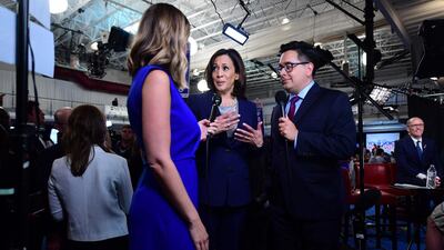 Senator Kamala Harris, centre, speaks with the press at the Spin Room. AFP