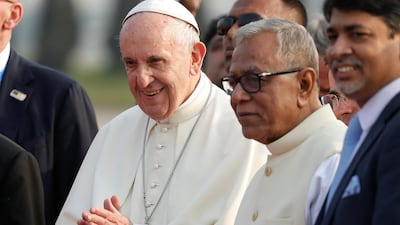 Pope Francis is accompanied by Bangladesh's President Abdul Hamid after arriving to Dhaka. Damir Sagolj / Reuters