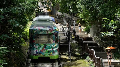 A Peak Tram passes uphill of the Victoria Peak in Hong Kong on June 16, 2021. Vincent Yu / AP Photo