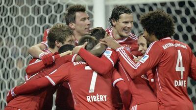 Franck Ribery, centre, is joined by teammates after scoring his third goal for Bayern on Saturday, Martin Meissner / AP