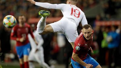 Czech Republic's Vladimir Coufal, right, duels for the ball with England's Ross Barkley during the Euro 2020 group A qualifying soccer match between Czech Republic and England at the Sinobo stadium in Prague, Czech Republic. AP Photo