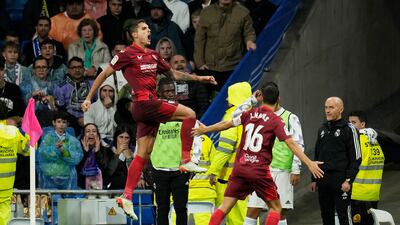 Erik Lamela, left, celebrates after scoring Sevilla's equaliser against Real Madrid. AP