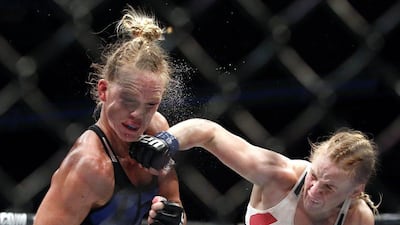 Valentina Shevchenko, right, of Kyrgyzstan, punches Holly Holm during a women's bantamweight mixed martial arts bout at UFC Chicago on Saturday. Nam Y Huh / AP Photo / July 23, 2016