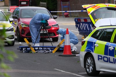 Police gather evidence at the site where two people were stabbed in Golders Green, north London. Getty Images