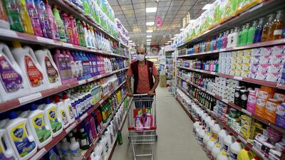 A Palestinian man wearing a mask pushes a cart with disinfectants in a supermarket in the southern Gaza Strip. Reuters