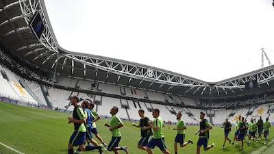 Juventus players warm up during a training session for media on Monday in Turin ahead of the Champions League final. Vlaerio Pennecino / Getty Images