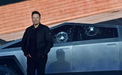Musk stands in front of cracked windows during the eventful launch. AFP