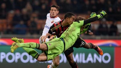 The AC Milan goalkeeper Gabriel and defender Urby Emanuelson collide while going for the ball during their Serie A match against Roma on Monday. Claudio Villa / Getty Images