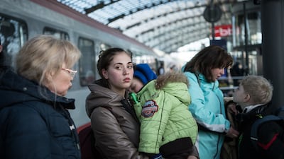 People fleeing Ukraine arrive on a train at the main railway station in Berlin. Getty