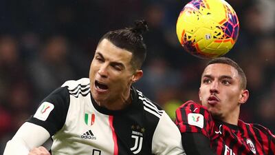 Cristiano Ronaldo beats AC Milan's Ismael Bennacer to a header. AFP