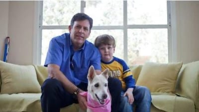Bodhi Brandes and his son Bentley with Sydney, who is deaf and blind. But she has found her place in the family pack. Razan Alzayani / The National