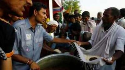 Villagers receive food at a temporary relief camp at a railway station in Bihar.