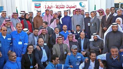 Kuwaiti Oil Minister Khaled Al Fadhel and Prince Abdulaziz bin Salman pose for a group photo with employees of the Kuwait Gulf Oil Company and Saudi Arabian Chevron, during a ceremony marking the signing of an agreement to reproduce oil in the neutral zone between the two countries, at Wafra about 100 kilometres south of Kuwait City. AFP