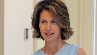 This handout picture released by the Syrian Presidency Facebook page on August 8, 2018, shows the Syrian First Lady Asma Al Assad carrying papers as she begins treatment for early-stage breast cancer at a hospital in the capital Damascus. AFP