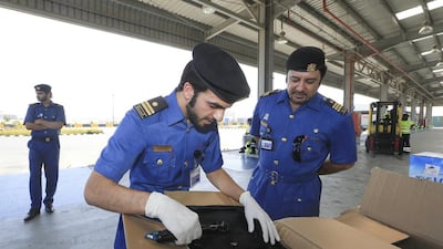 Dubai Customs inspectors swab a shipment to detect explosive residue from a shipment unloaded in Jebel Ali Port. Sarah Dea / The National