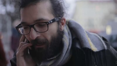 Ayham Majid Agha takes a call about a role in Berlin, where he works as an actor and playwright. Courtesy Nigol Bezjian
