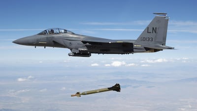An F-15E Strike Eagle aircraft releases a GBU-28 'bunker buster' bomb over a Utah test range. Israel has 100 of the 160 stockpile of the bombs as pressure grows on US defence industry to make more munitions. Alamy