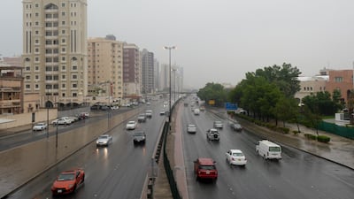 Vehicles drive on a road during rainfall in Kuwait City. EPA