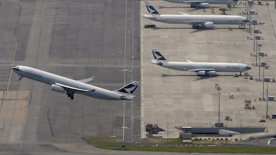 A Cathay Pacific Airways flight takes off at Hong Kong Airport. The carrier has reported a huge fall in earnings. Bobby Yip / Reuters