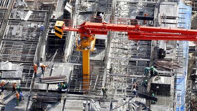 Labourers work at the construction site of an apartment building in Hanoi. Vietnam has eased restrictions on buyers from overseas. Kham / Reuters