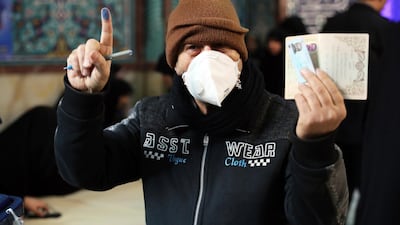 A voter shows his identification and inked finger while voting for the parliamentary elections at a polling station in Tehran, Iran. Iranians began voting for a new parliament on Friday, with turnout seen as a key measure of support for Iran's leadership as sanctions weigh on the economy and isolate the country diplomatically. AP Photo