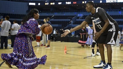Andrew Wiggins, right, of the Minnesota Timberwolves conducts a drill with a player from the Tarahumara women's basketball team during an NBA clinic in Mexico City on Tuesday. Yuri Cortez / AFP