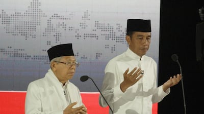 Indonesian President Joko Widodo and running mate Ma'ruf Amin praying before the start of the final presidential debate against challenger Prabowo Subianto and his running mate Sandiaga Uno in Jakarta. AFP